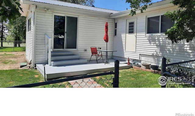 15296 County Road 39, Sterling, CO 80751 - view of front of home with a wooden deck, a metal roof, and entry steps