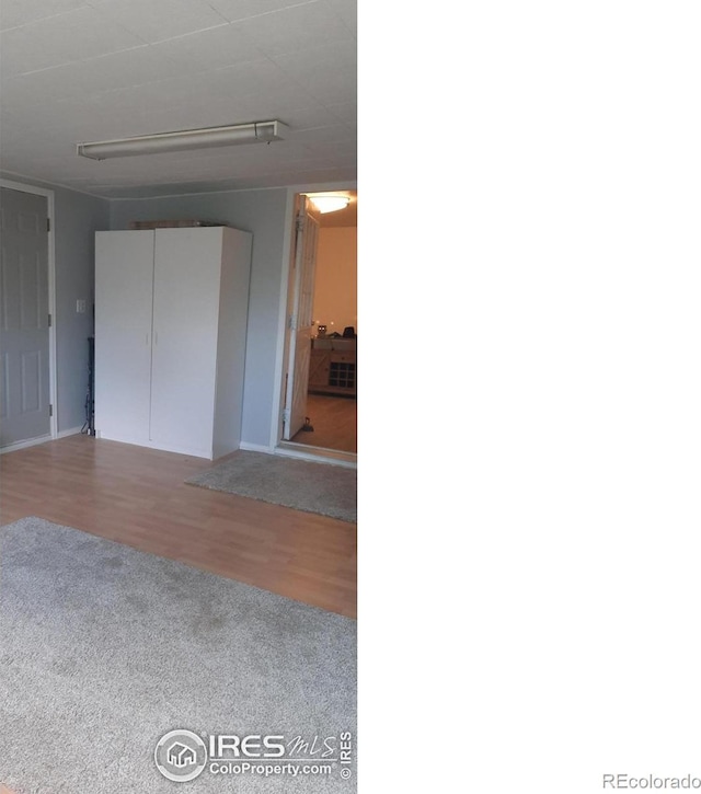 15296 County Road 39, Sterling, CO 80751 - unfurnished bedroom with carpet flooring, wood finished floors, and a closet