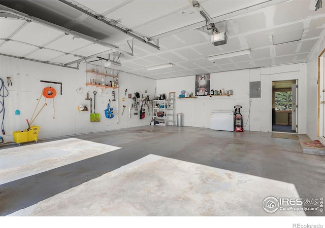 108 40th Ave, Greeley, CO 80634 - garage with a garage door opener, electric panel, and a workshop area