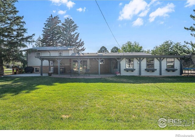 108 40th Ave, Greeley, CO 80634 - back of house with a patio area and a lawn