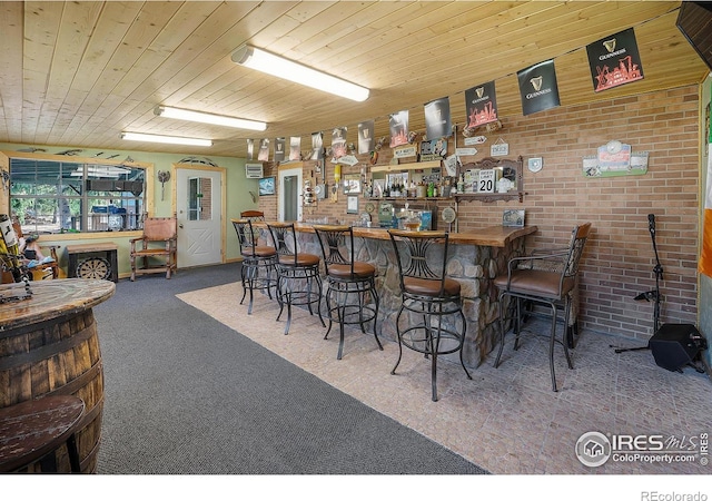 108 40th Ave, Greeley, CO 80634 - community bar area with carpet floors, wooden ceiling, and brick wall