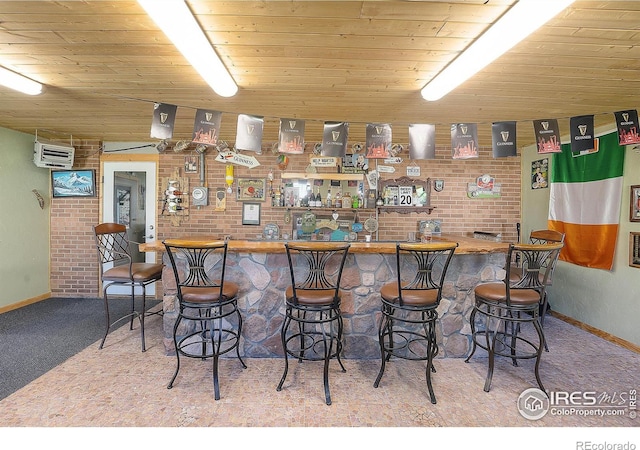 108 40th Ave, Greeley, CO 80634 - indoor wet bar featuring carpet floors, wooden ceiling, a wall mounted AC, and brick wall
