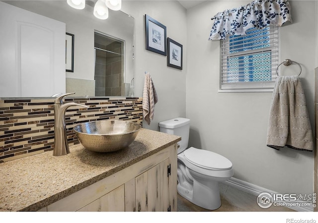 108 40th Ave, Greeley, CO 80634 - bathroom featuring decorative backsplash, vanity, and a shower
