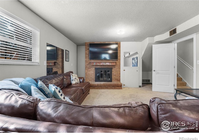 108 40th Ave, Greeley, CO 80634 - carpeted living room featuring a brick fireplace, a textured ceiling, and stairway