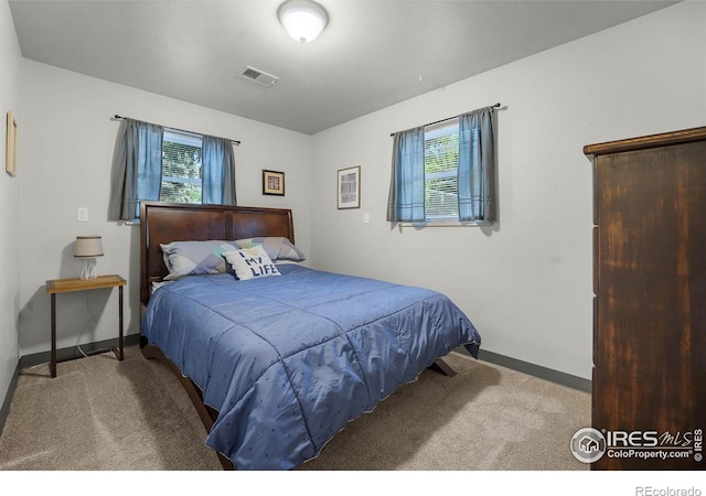 108 40th Ave, Greeley, CO 80634 - carpeted bedroom featuring multiple windows