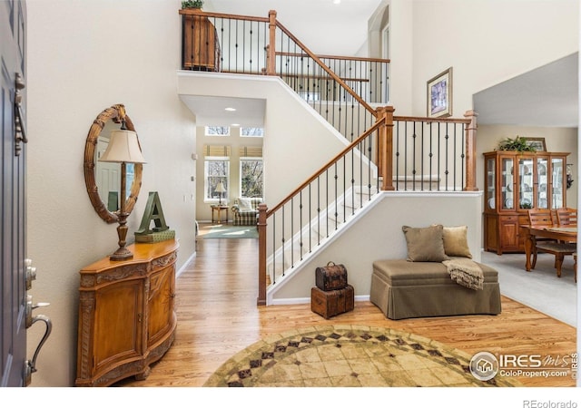 11722 Elmer Linn Dr, Longmont, CO 80504 - foyer entrance with wood finished floors, a towering ceiling, and stairway