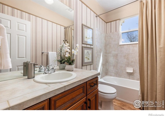 11722 Elmer Linn Dr, Longmont, CO 80504 - full bath featuring vanity, shower / bathtub combination with curtain, wood finished floors, and wallpapered walls