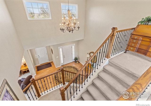 11722 Elmer Linn Dr, Longmont, CO 80504 - foyer entrance featuring a towering ceiling, a chandelier, and stairs