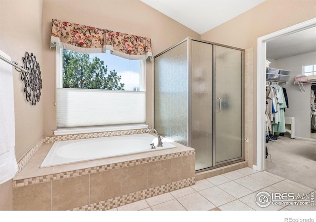 11722 Elmer Linn Dr, Longmont, CO 80504 - full bathroom featuring a shower stall, a bath, a walk in closet, and tile patterned flooring