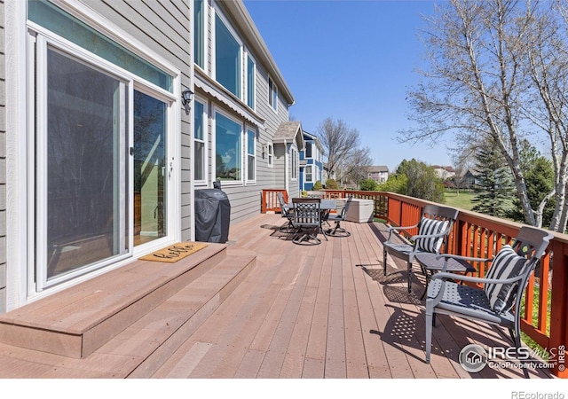 11722 Elmer Linn Dr, Longmont, CO 80504 - wooden terrace with outdoor dining area and area for grilling