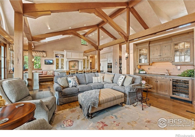 6619 Ridgeline Dr, Timnath, CO 80547 - living area featuring wine cooler, high vaulted ceiling, wood finished floors, beam ceiling, and recessed lighting