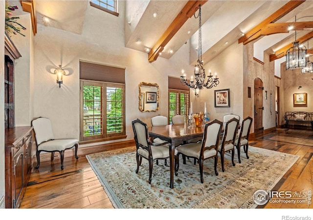6619 Ridgeline Dr, Timnath, CO 80547 - dining space featuring a chandelier, high vaulted ceiling, hardwood / wood-style floors, and beamed ceiling