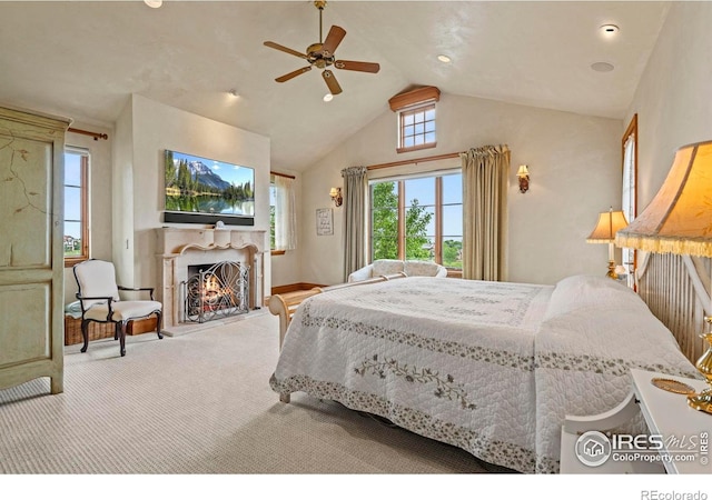 6619 Ridgeline Dr, Timnath, CO 80547 - carpeted bedroom with lofted ceiling, a warm lit fireplace, and ceiling fan