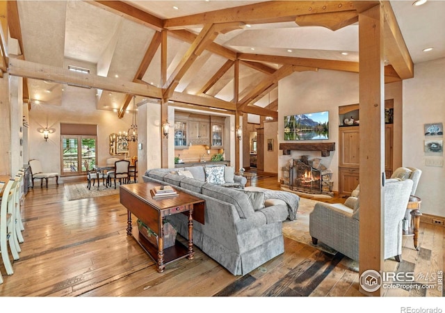 6619 Ridgeline Dr, Timnath, CO 80547 - living room featuring high vaulted ceiling, wood-type flooring, beam ceiling, recessed lighting, and a chandelier