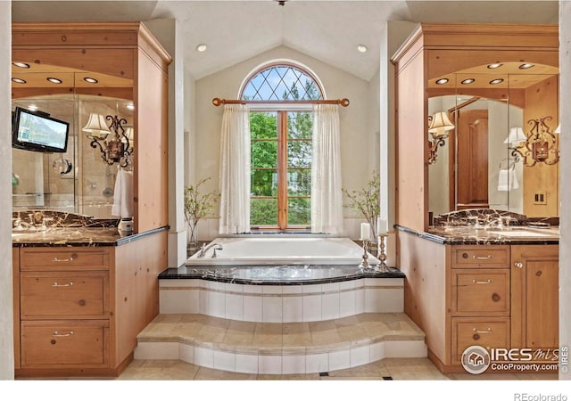 6619 Ridgeline Dr, Timnath, CO 80547 - full bath with vanity, lofted ceiling, a garden tub, tile patterned flooring, and a shower stall