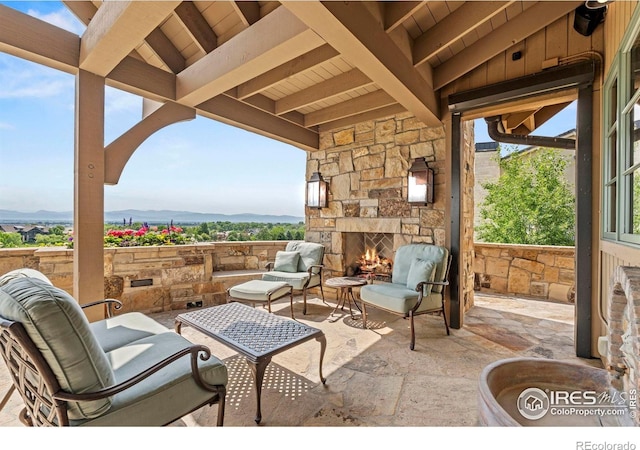 6619 Ridgeline Dr, Timnath, CO 80547 - view of patio / terrace featuring an outdoor stone fireplace