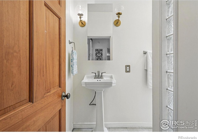 2955 Columbine St, Denver, CO 80205 - bathroom featuring baseboards and a sink