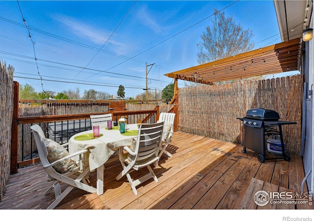 2955 Columbine St, Denver, CO 80205 - wooden deck with outdoor dining area, area for grilling, and a fenced backyard