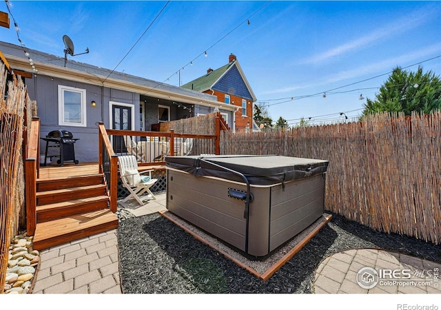 2955 Columbine St, Denver, CO 80205 - back of property featuring a hot tub, a fenced backyard, a wooden deck, and a patio