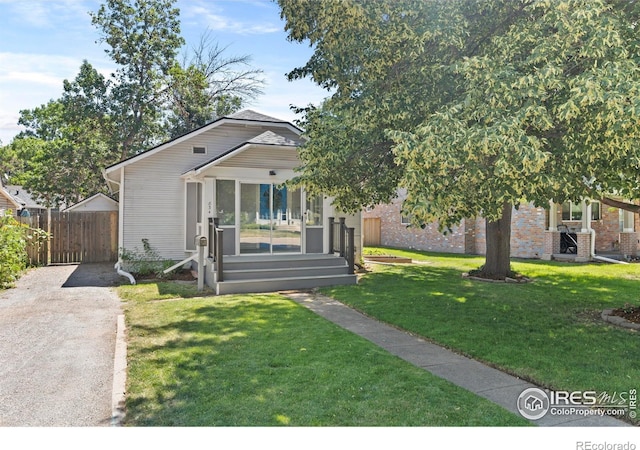 834 Emery St, Longmont, CO 80501 - view of front of home with brick siding and driveway