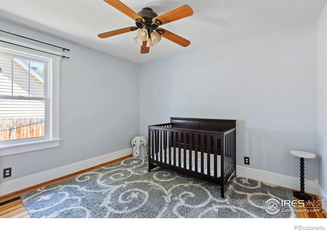834 Emery St, Longmont, CO 80501 - bedroom with a crib and a ceiling fan