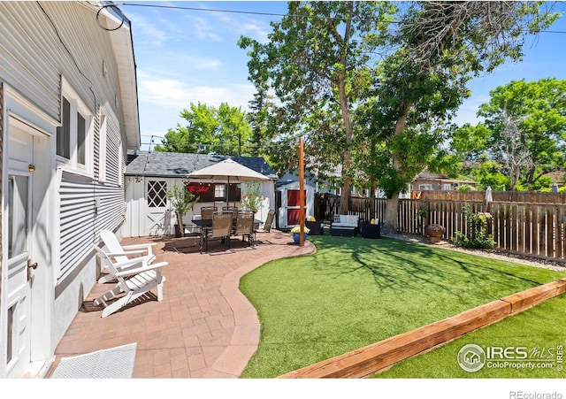 834 Emery St, Longmont, CO 80501 - fenced backyard with a patio area, a shed, and outdoor dining space