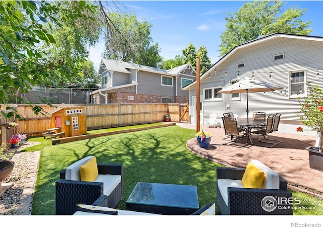 834 Emery St, Longmont, CO 80501 - fenced backyard with a patio and outdoor lounge area