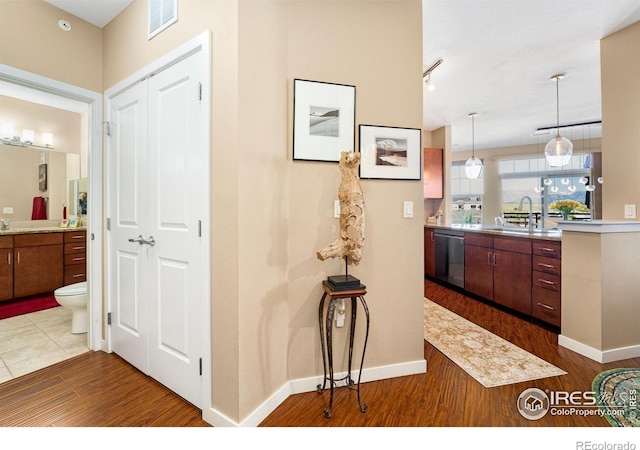 13598 Via Varra Unit 412, Broomfield, CO 80020 - hall featuring a sink and dark wood-style flooring