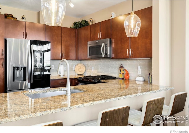 13598 Via Varra Unit 412, Broomfield, CO 80020 - kitchen featuring appliances with stainless steel finishes, light stone countertops, decorative backsplash, and decorative light fixtures