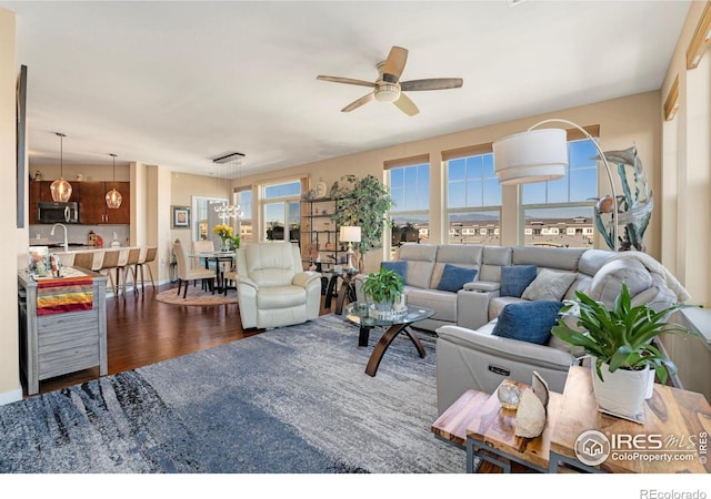13598 Via Varra Unit 412, Broomfield, CO 80020 - living room featuring ceiling fan, dark wood-style floors, and a chandelier