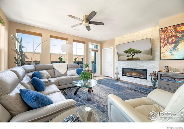 13598 Via Varra Unit 412, Broomfield, CO 80020 - living room featuring a ceiling fan and a stone fireplace