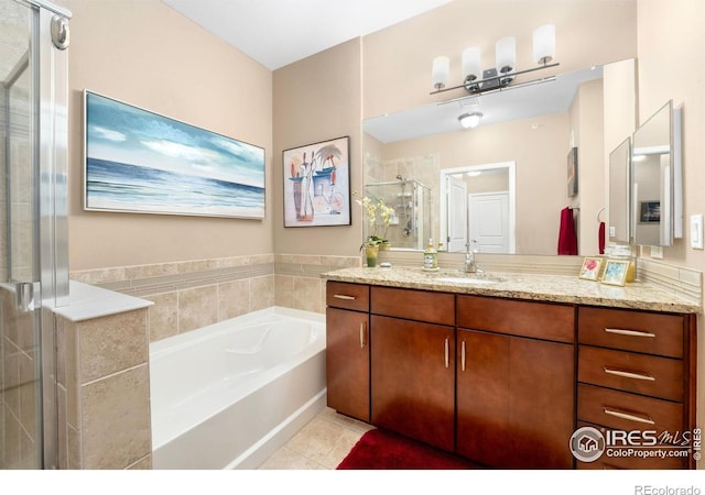 13598 Via Varra Unit 412, Broomfield, CO 80020 - full bathroom featuring vanity, tile patterned flooring, a garden tub, and a shower stall