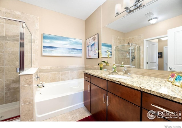 13598 Via Varra Unit 412, Broomfield, CO 80020 - full bathroom with vanity, a shower stall, a garden tub, and tile patterned floors