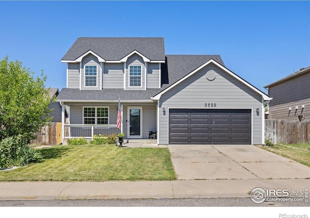 3233 Baldwin Ave, Evans, CO 80620 - traditional-style home featuring an attached garage, driveway, covered porch, and roof with shingles