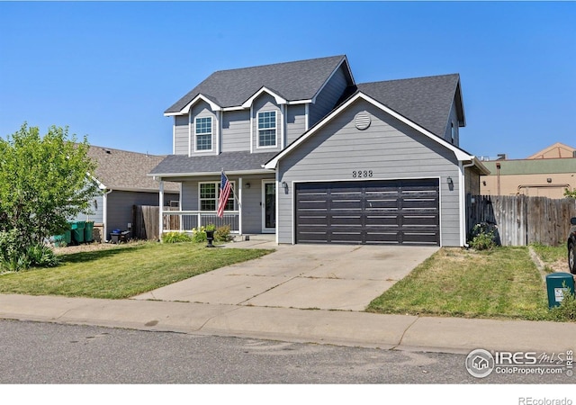 3233 Baldwin Ave, Evans, CO 80620 - traditional home with an attached garage, a porch, concrete driveway, and a shingled roof