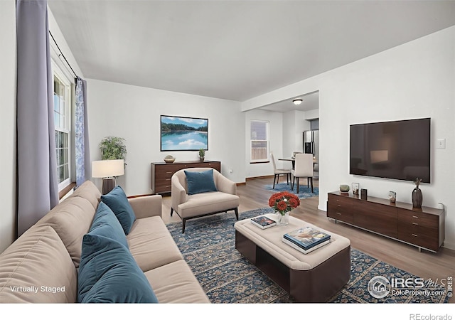3233 Baldwin Ave, Evans, CO 80620 - living area featuring wood finished floors and baseboards