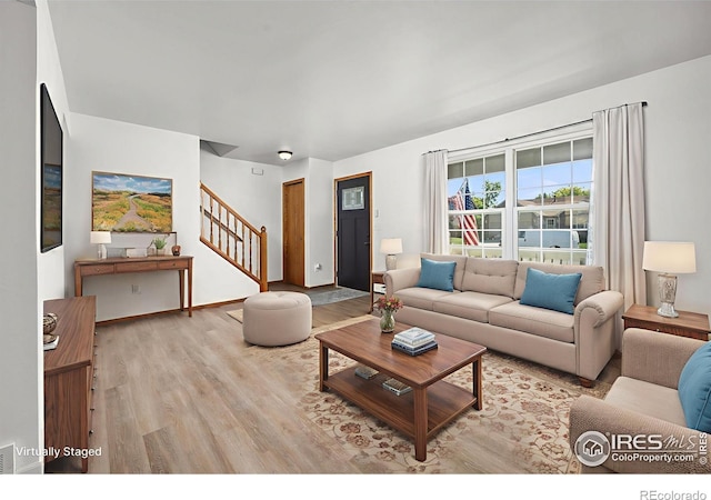 3233 Baldwin Ave, Evans, CO 80620 - living room with stairs and light wood finished floors