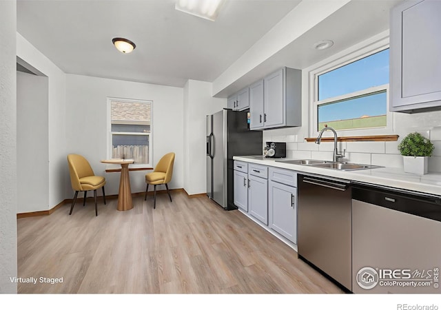 3233 Baldwin Ave, Evans, CO 80620 - kitchen with dishwashing machine, stainless steel fridge, tasteful backsplash, and light countertops