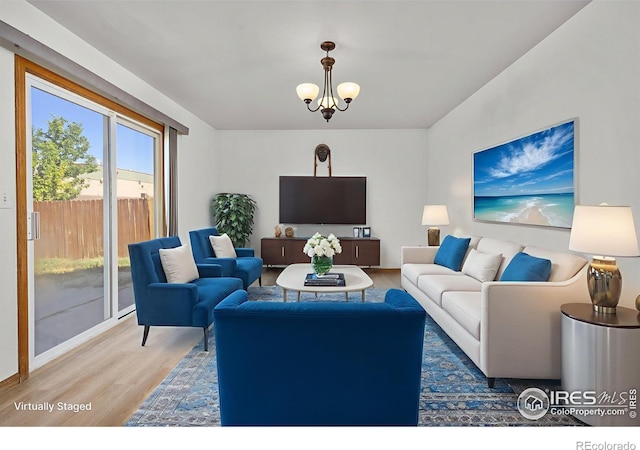 3233 Baldwin Ave, Evans, CO 80620 - living room featuring wood finished floors and a chandelier