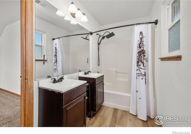 3233 Baldwin Ave, Evans, CO 80620 - full bathroom with shower / bath combo, vanity, and wood finished floors