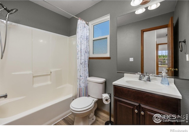 3233 Baldwin Ave, Evans, CO 80620 - bathroom with wood finished floors, shower / bath combo, vanity, and a textured wall