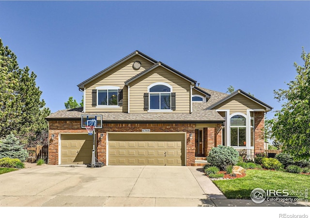 6366 Umber Cir, Arvada, CO 80403 - view of front of house with brick siding, roof with shingles, driveway, and a garage