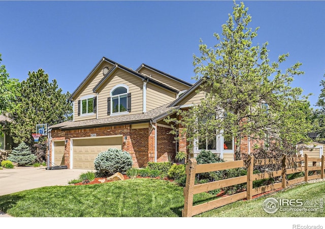 6366 Umber Cir, Arvada, CO 80403 - view of front of home with a garage, driveway, and brick siding