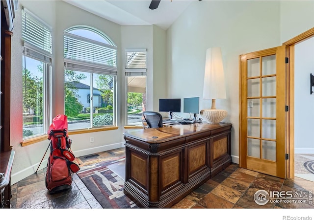 6366 Umber Cir, Arvada, CO 80403 - home office with healthy amount of natural light, stone tile floors, high vaulted ceiling, and ceiling fan