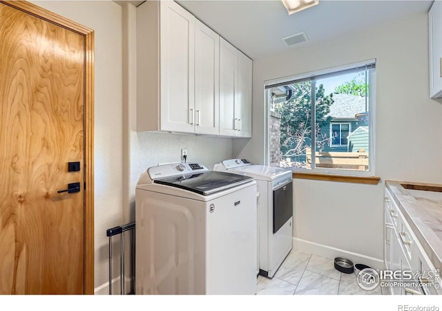 6366 Umber Cir, Arvada, CO 80403 - laundry area with cabinet space, separate washer and dryer, and light marble finish flooring