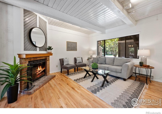 1220 Solstice Ln, Fort Collins, CO 80525 - living area featuring a baseboard radiator, a fireplace, wood finished floors, and beam ceiling