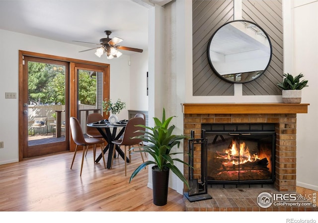1220 Solstice Ln, Fort Collins, CO 80525 - dining area featuring a fireplace, wood finished floors, and a ceiling fan