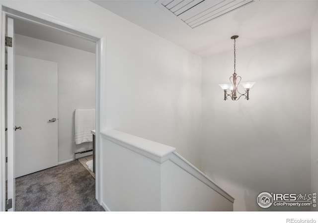 1220 Solstice Ln, Fort Collins, CO 80525 - hall featuring carpet floors, an upstairs landing, a chandelier, and a baseboard radiator