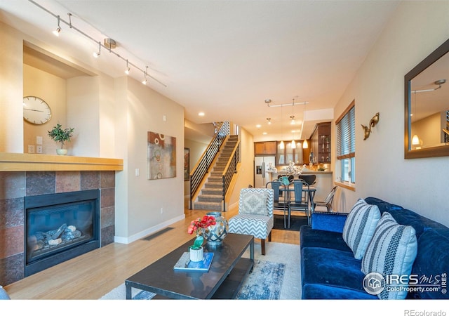 5060 Pierre St Unit E, Boulder, CO 80304 - living area with wood finished floors, track lighting, stairs, and a fireplace