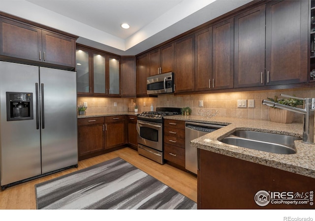 5060 Pierre St Unit E, Boulder, CO 80304 - kitchen featuring stainless steel appliances, light wood-style flooring, light stone countertops, decorative backsplash, and recessed lighting